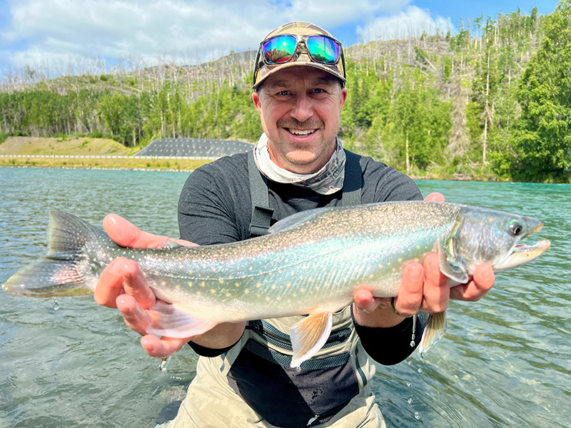 Erhardt holding a fish in the river
