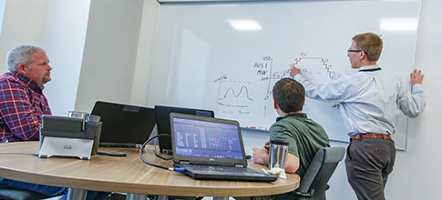 men looking at whiteboard