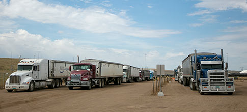 three semi trucks parked