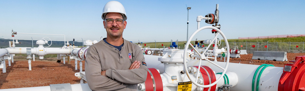 Employee in front of pipeline