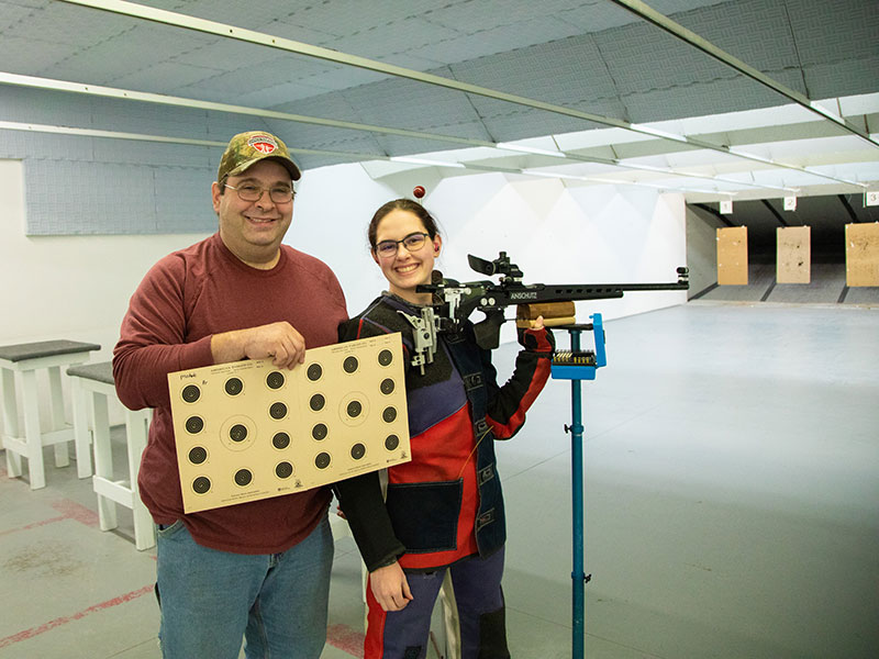 father and daughter with gun